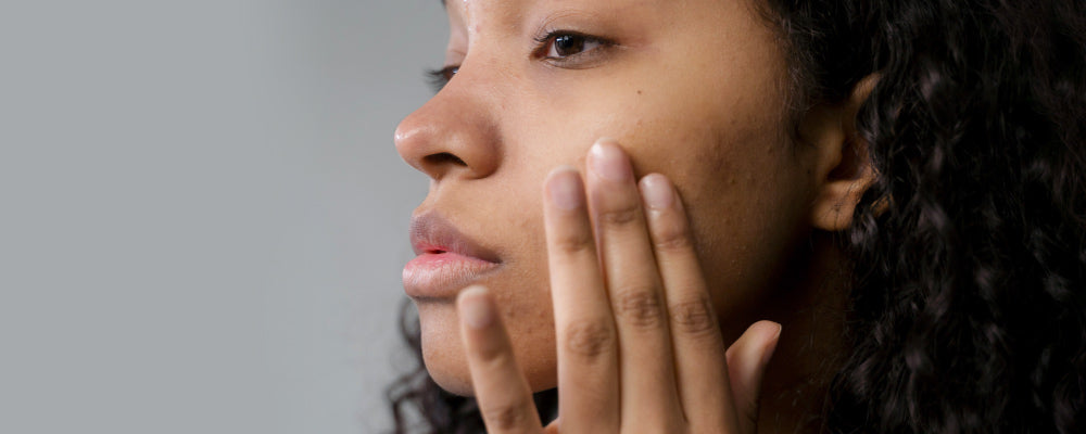 Woman touching her cheek