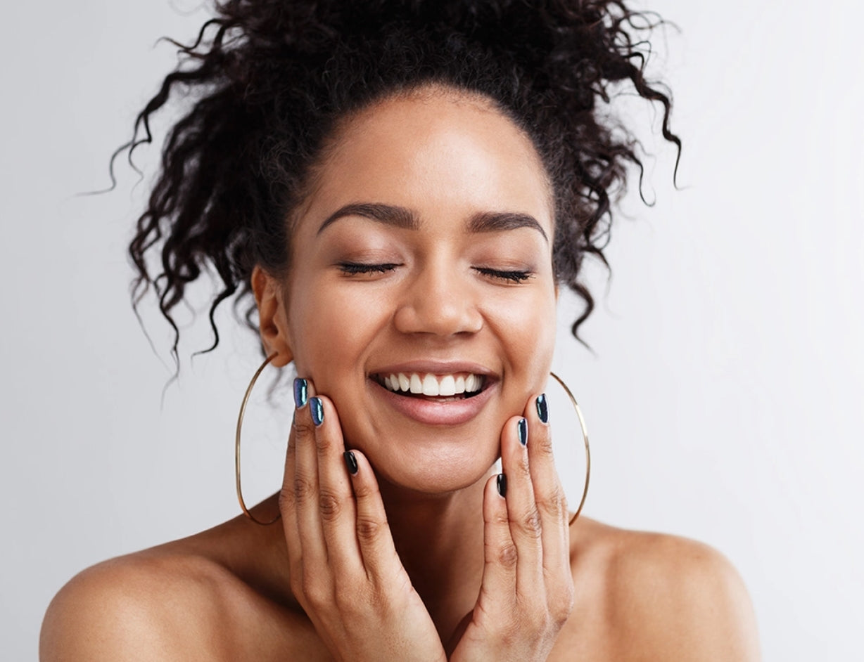 Young Woman Smiling and Touching her Face