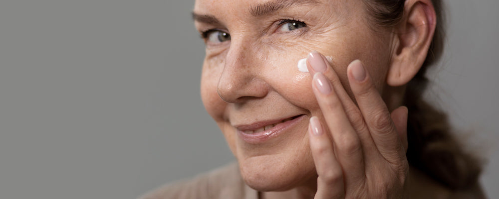 Woman putting lotion on her face